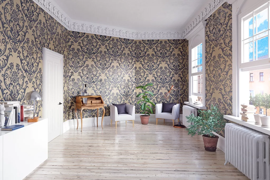 The interior of a living room with hardwood floors and vintage style wallpaper on the walls