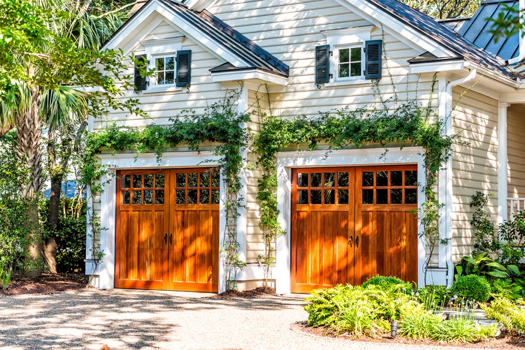 A house with white exterior paint and vines growing on the walls