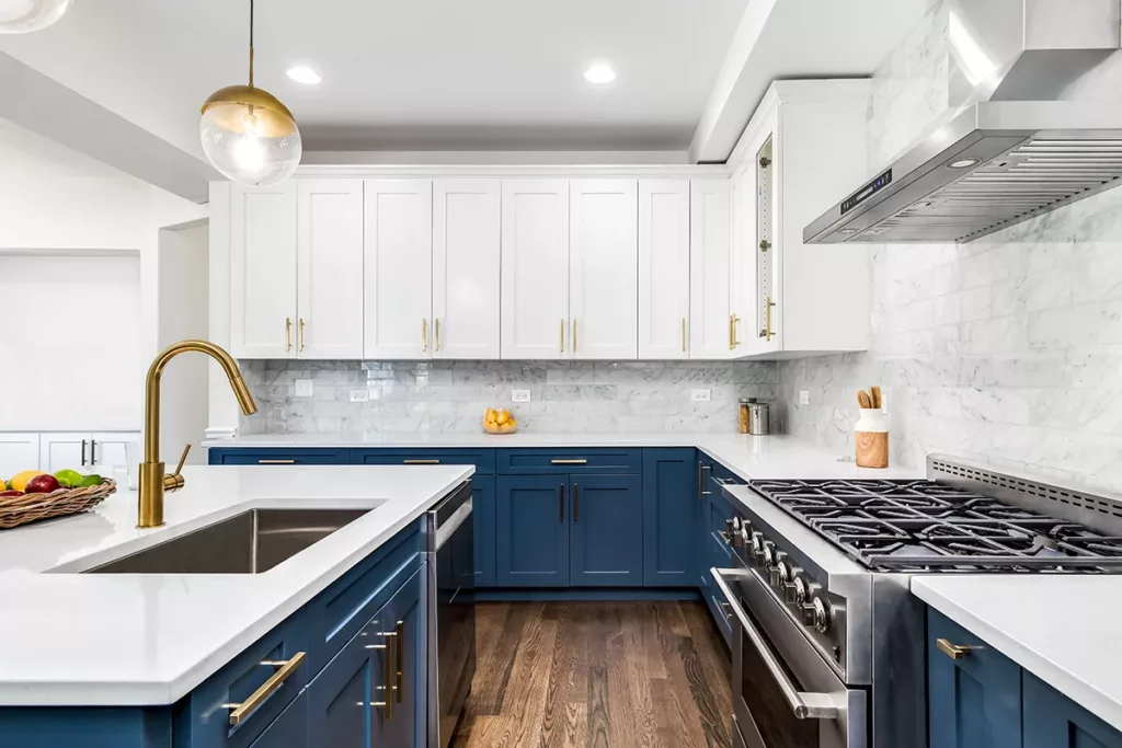 A modern and newly painted kitchen with white and dark blue kitchen cabinets