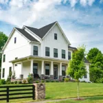 The exterior of a white house with a fresh paint job, showing the concept of boosting curb appeal when selling a home