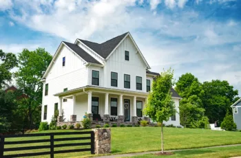 The exterior of a white house with a fresh paint job, showing the concept of boosting curb appeal when selling a home