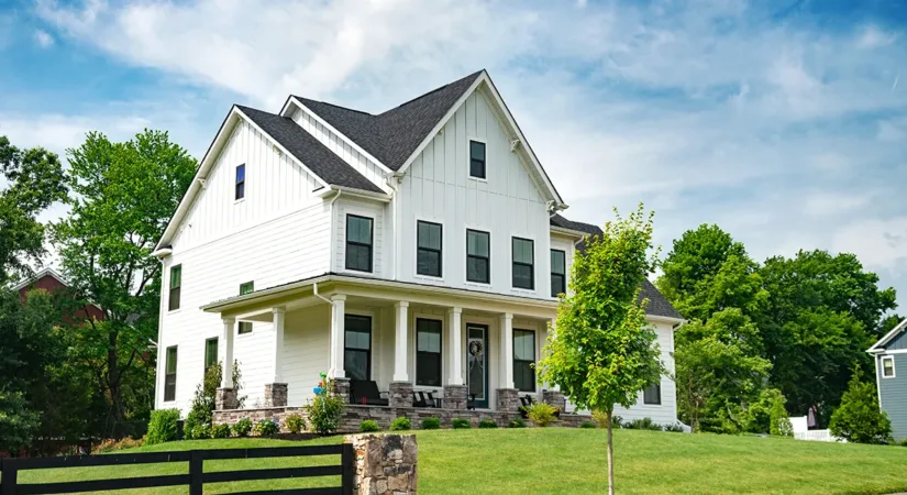 The exterior of a white house with a fresh paint job, showing the concept of boosting curb appeal when selling a home